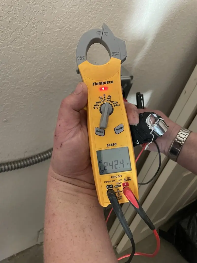 Voltage testing with clamp meter during Recessed Lighting Installation in Redland